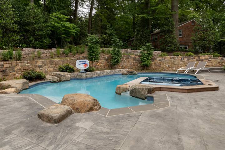 Natural stone pool and spa set into a landscaped hillside in McLean, Virginia